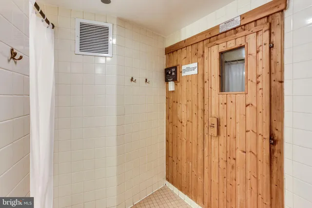 a bathroom with a shower and a sink