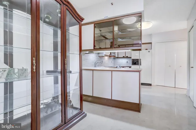 a bathroom with a granite countertop sink a mirror and a shower