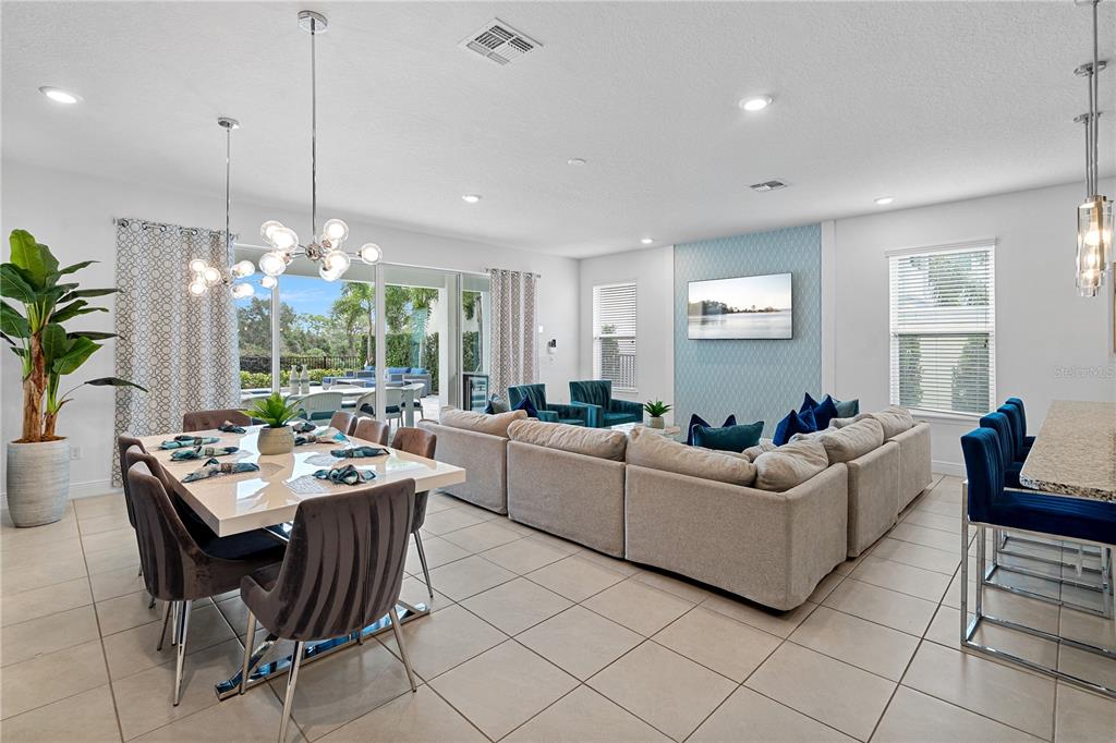 7622 Excitement Drive Reunion, FL 34747 - Photo 12 of 46 a living room with furniture a chandelier and a large window
