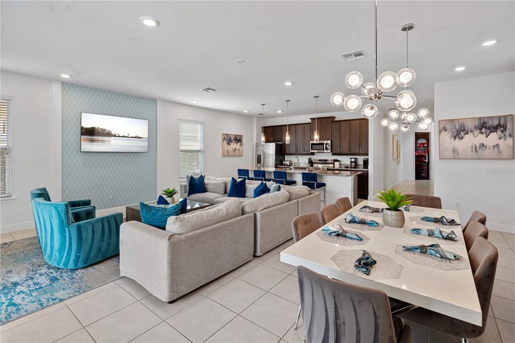 7622 Excitement Drive Reunion, FL 34747 - Photo 17 of 46 a living room with kitchen island furniture and a chandelier