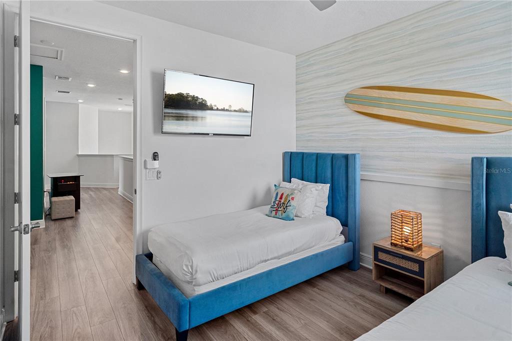 7622 Excitement Drive Reunion, FL 34747 - Photo 28 of 46 a bedroom with a bed and wooden floor