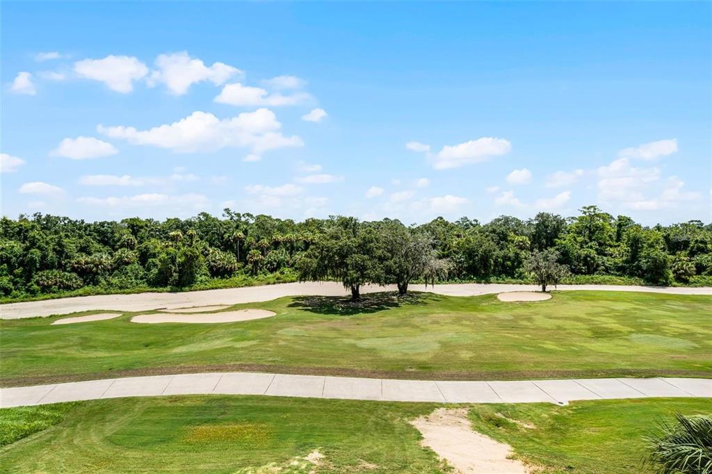 7622 Excitement Drive Reunion, FL 34747 - Photo 37 of 46 a view of a golf course with a lake