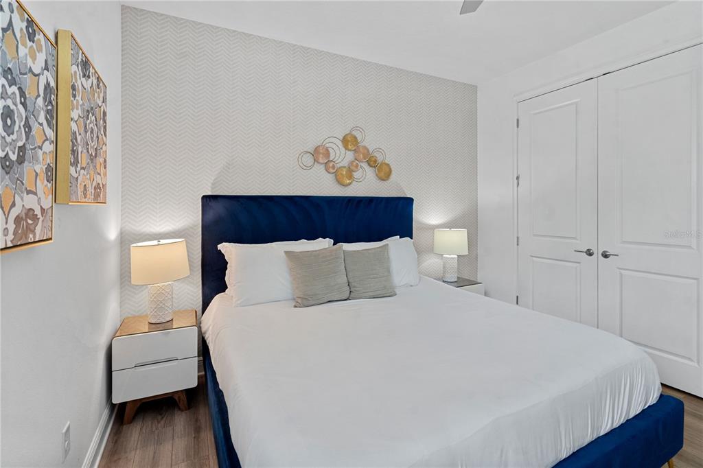 7622 Excitement Drive Reunion, FL 34747 - Photo 6 of 46 a bedroom with a bed and a painting on the wall