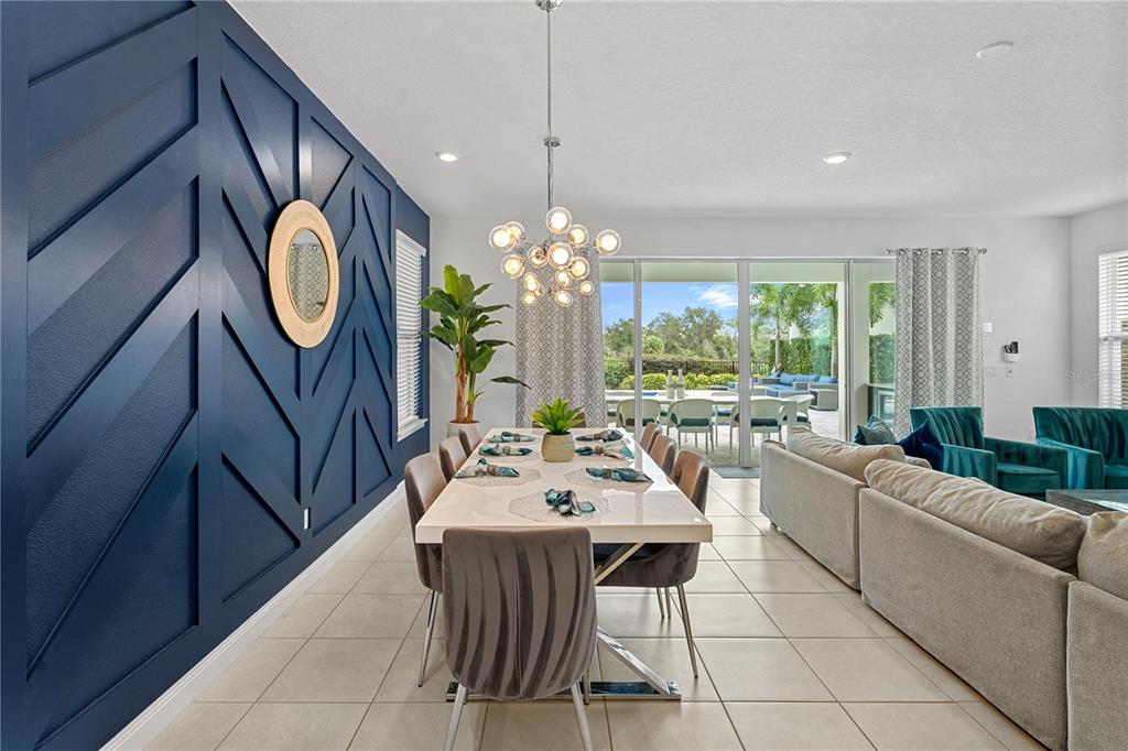 7622 Excitement Drive Reunion, FL 34747 - Photo 10 of 46 a living room with furniture a chandelier a large window and a rug