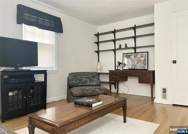 a bedroom with two beds and a dresser