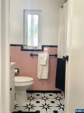 a bedroom with a bed dresser and a window