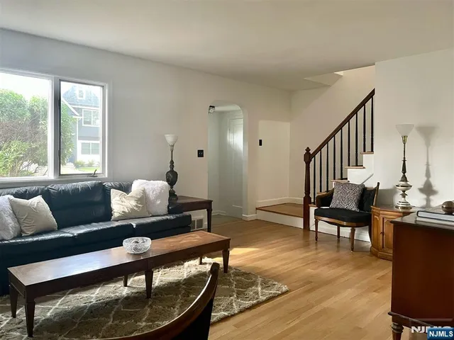 a view of a a dining room with furniture window and wooden floor