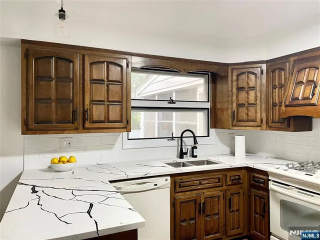 a view of a kitchen with a dining table chairs and wooden floor