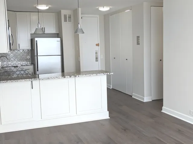 a view of kitchen with wooden floor