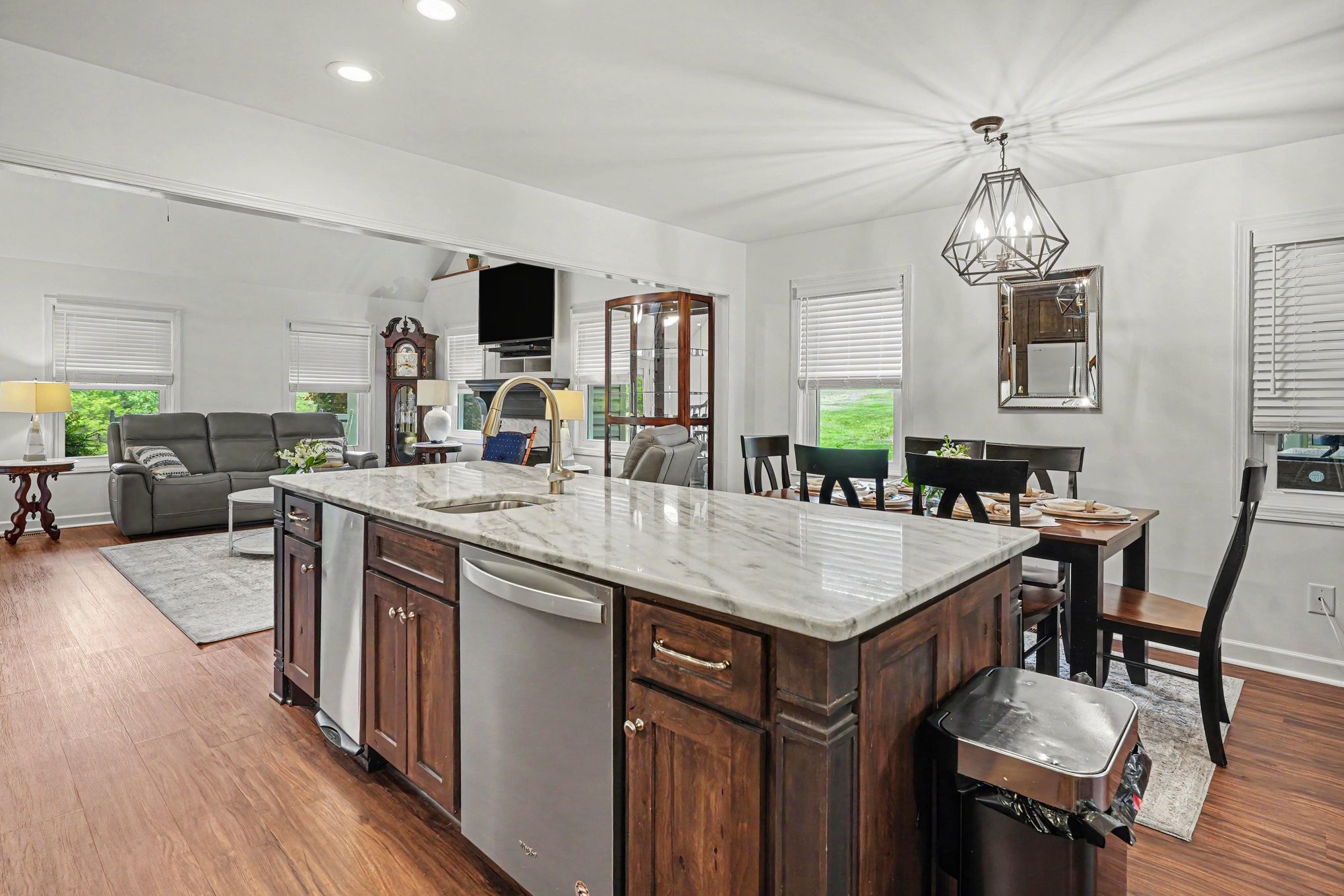 5833 Highway 76 East Springfield, TN 37172 - Photo 17 of 66 a kitchen with stainless steel appliances granite countertop a stove a refrigerator a kitchen island a sink dishwasher a dining table and chairs with wooden floor
