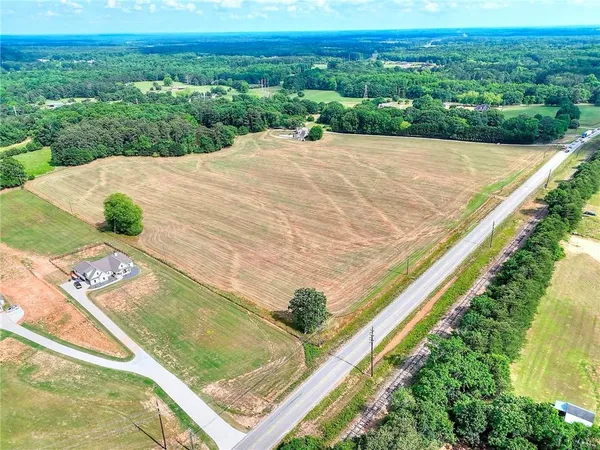 a view of a field with a mountain in the background