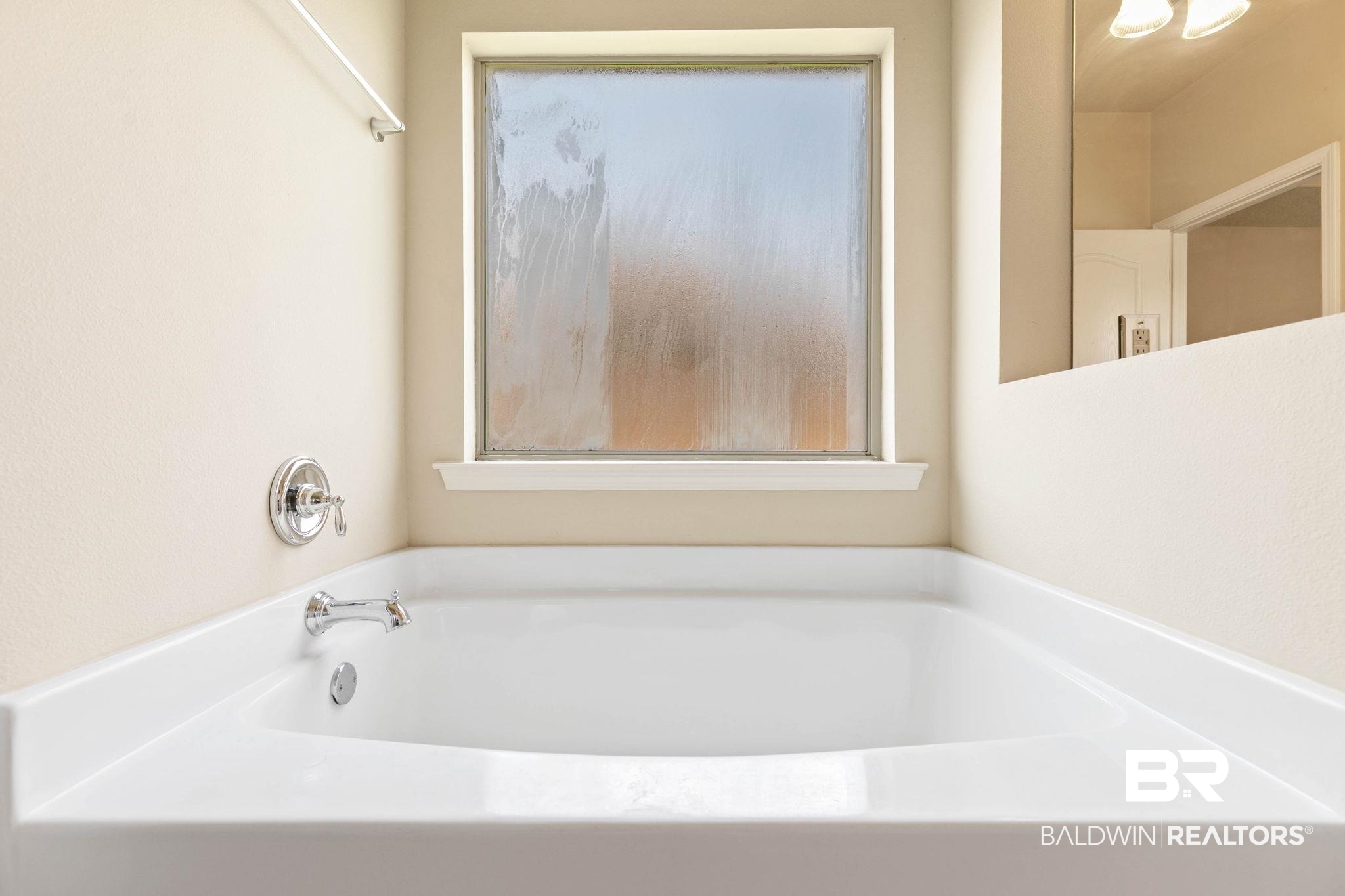 2216 Livingstone Court Mobile, AL 36695 - Photo 28 of 62 Soaking tub with chrome fixtures and a privacy window