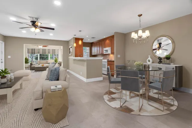 a kitchen that has a sink a stove and a microwave oven