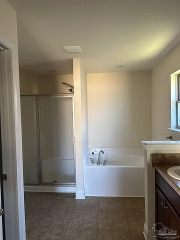 a bathroom with a tub and shower