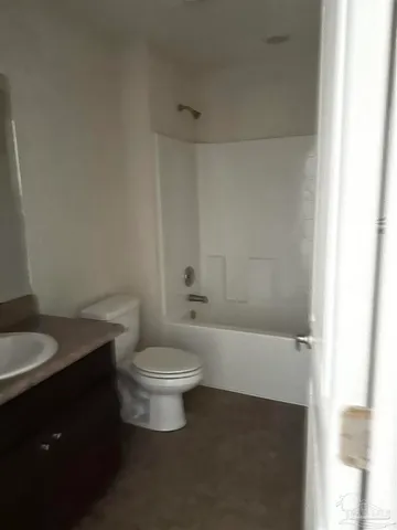 a bathroom with a toilet a sink and bathtub