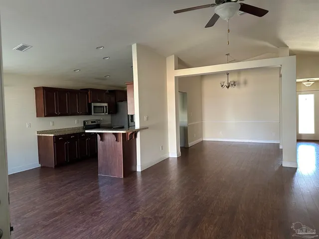 a view of kitchen with sink and wooden floor