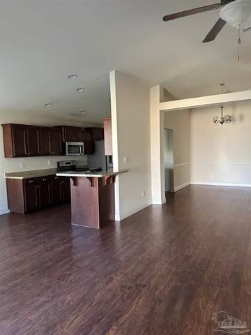 a view of kitchen with cabinets and wooden floor