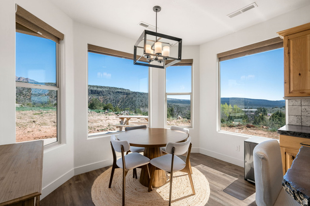 62 North Lucky 7 Road Veyo, UT 84782 - Photo 12 of 43 Dining room featuring a mountain view, wood finished floors, and suspended lighting