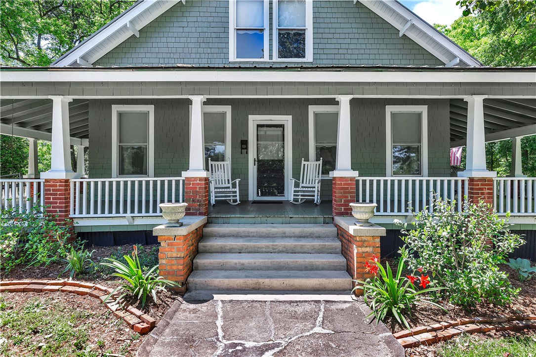 205 West Mauldin Street Walhalla, SC 29691 - Photo 2 of 43 A welcoming front porch, adorned with white railings, invites quiet contemplation on this charming facade.