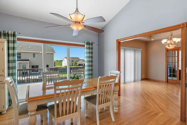 a dining room with furniture wooden floor and a chandelier