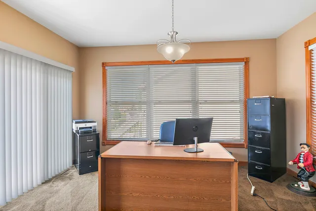 a workspace with furniture and chandelier