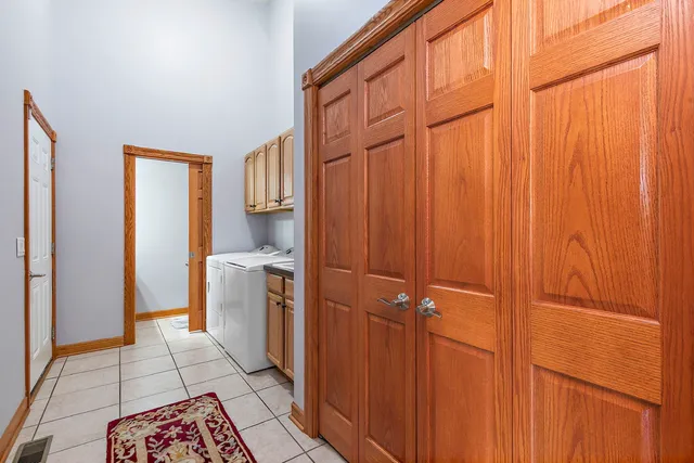 a room with a washing machine and a shower