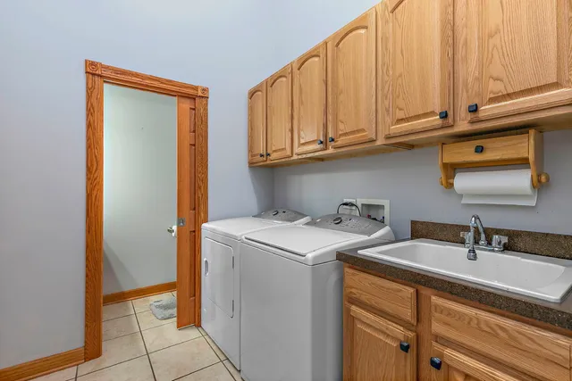 a utility room with sink dryer and washer