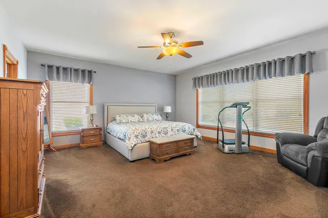 a bedroom with a bed couch and a window