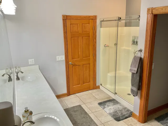 a bathroom with a shower and a glass door