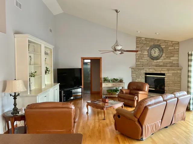 a living room with furniture a flat screen tv and a fireplace