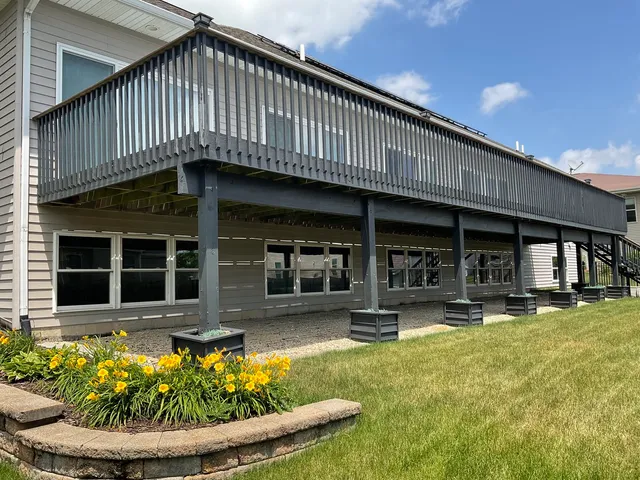 a front view of a house with swimming pool and porch
