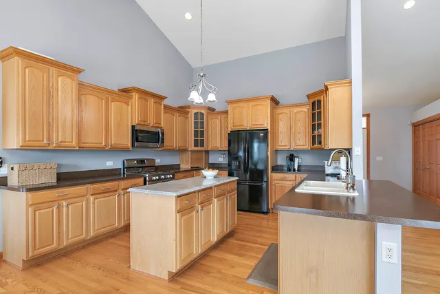 a kitchen with stainless steel appliances a stove refrigerator sink and a granite counter tops