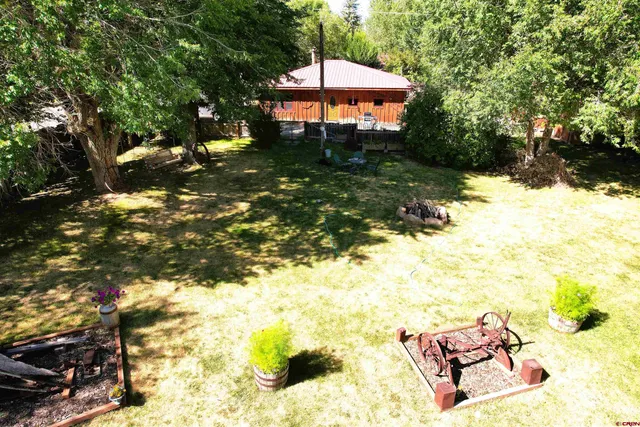 a backyard of a house with table and chairs