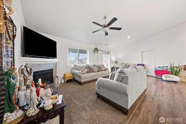 a living room with furniture a fireplace and a flat screen tv