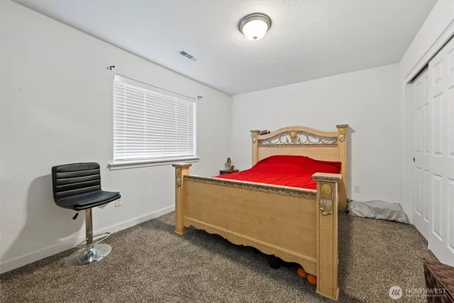 a living room with a bed furniture and a window