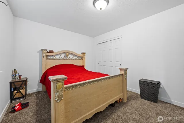 a bedroom with a bed and a closet