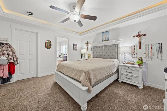 a bedroom with a bed and a chandelier