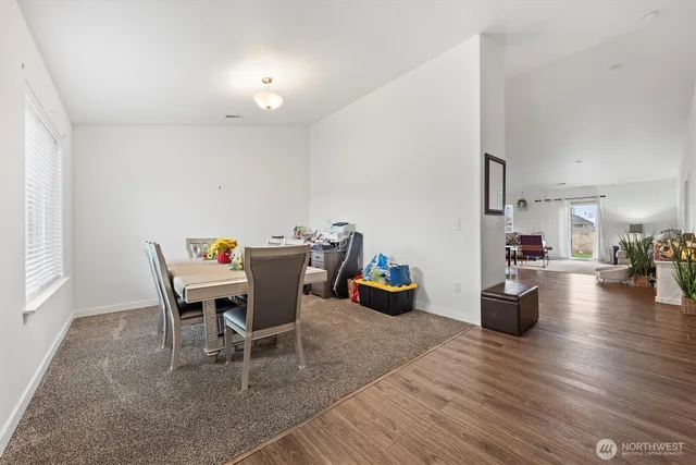 a dining room with furniture and wooden floor