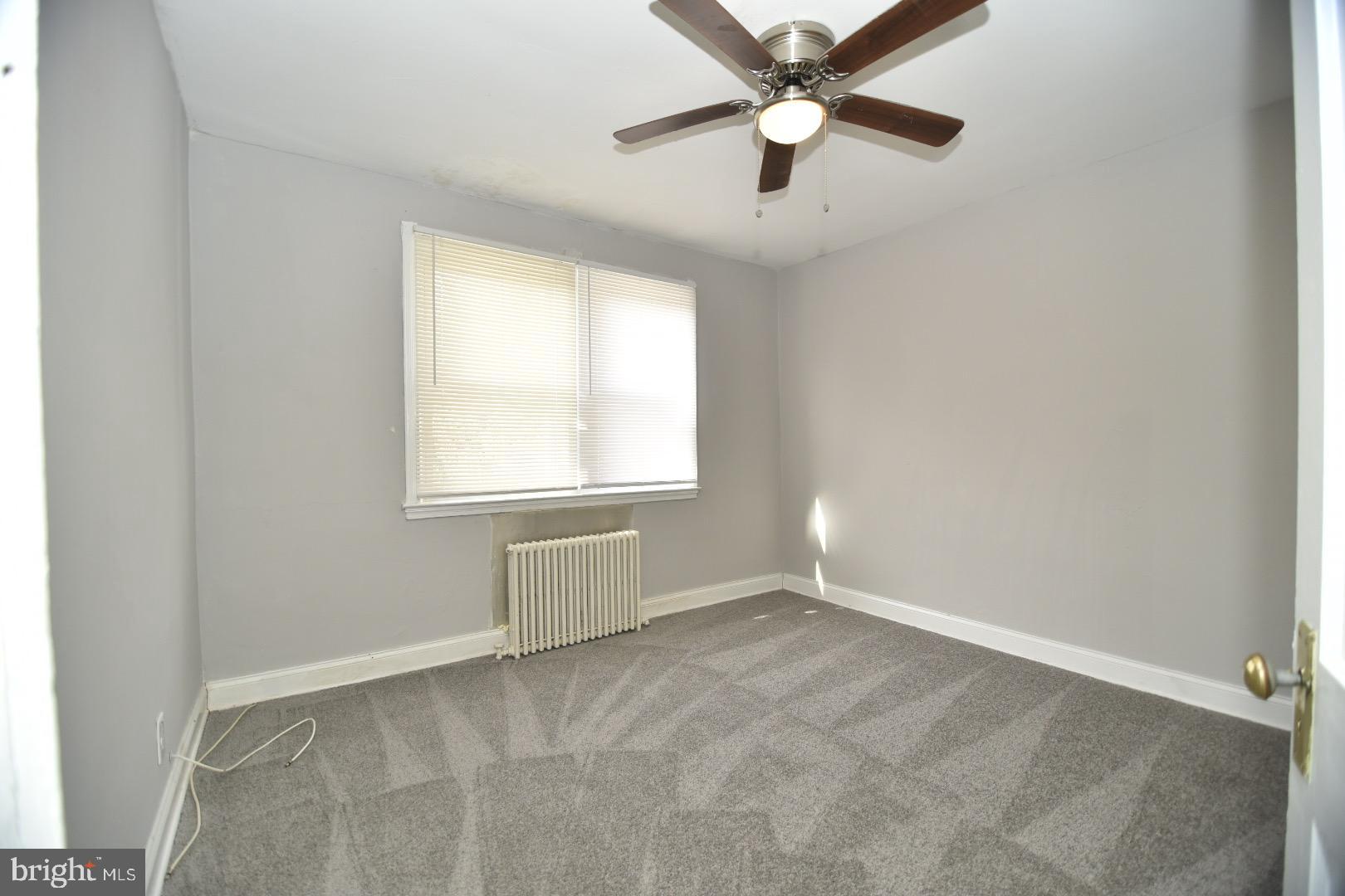 913 St Dunstans Road Baltimore, MD 21212 - Photo 5 of 28 an empty room with a window and a fan
