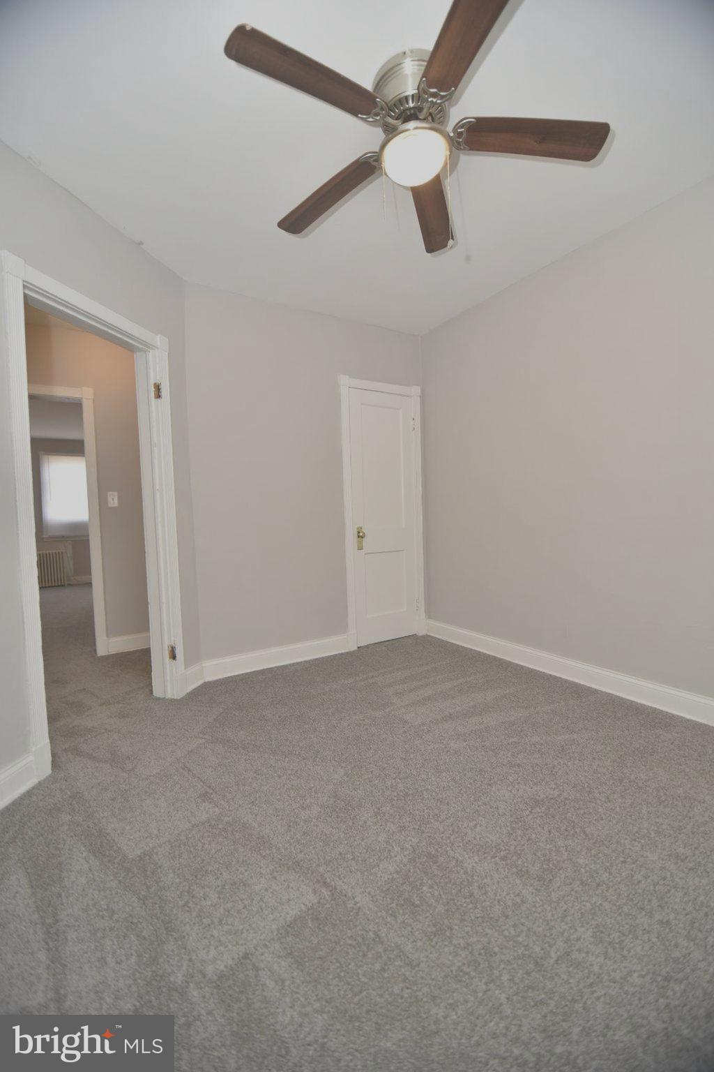 913 St Dunstans Road Baltimore, MD 21212 - Photo 7 of 28 en empty room with ceiling fan and window