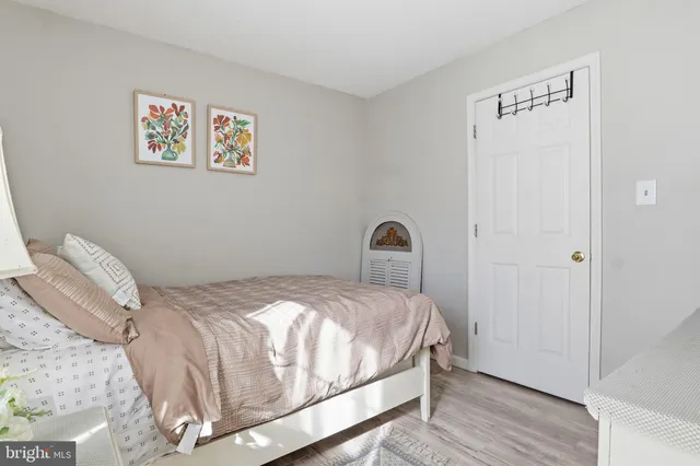 a bedroom with a bed and a painting on the wall