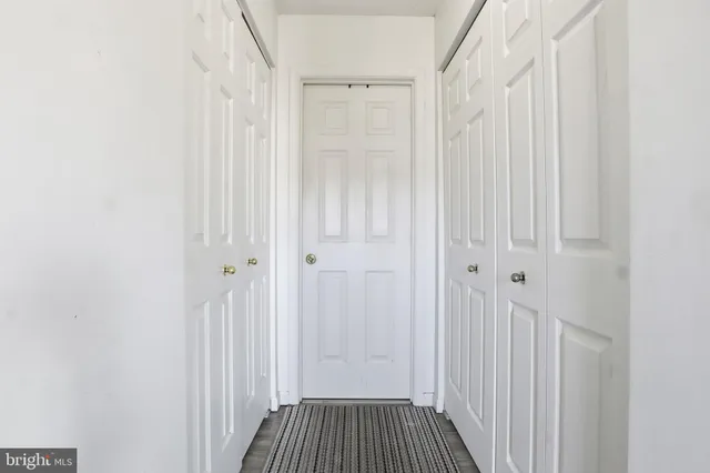 a view of a room with wooden floor