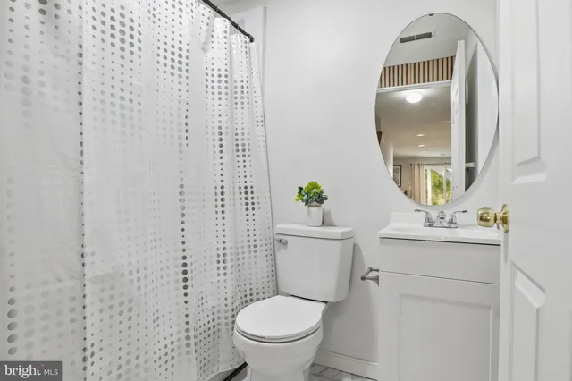 a white toilet sitting next to a bathroom sink