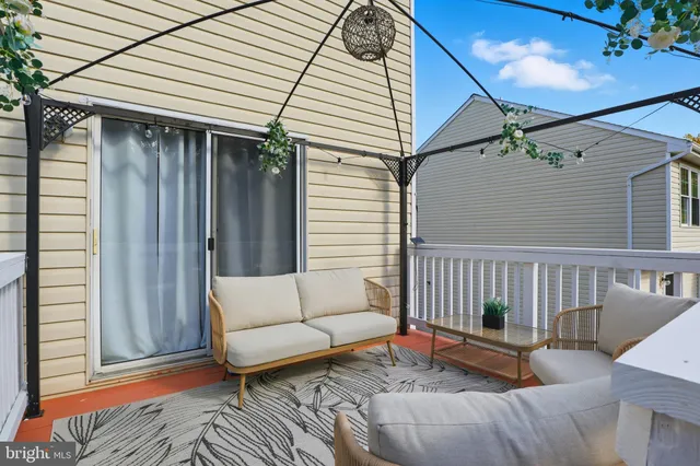 a view of a house with a yard and sitting area