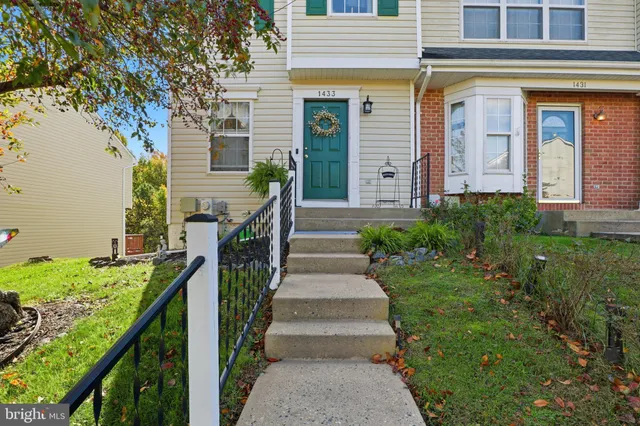 a view of a house with brick walls and stairs