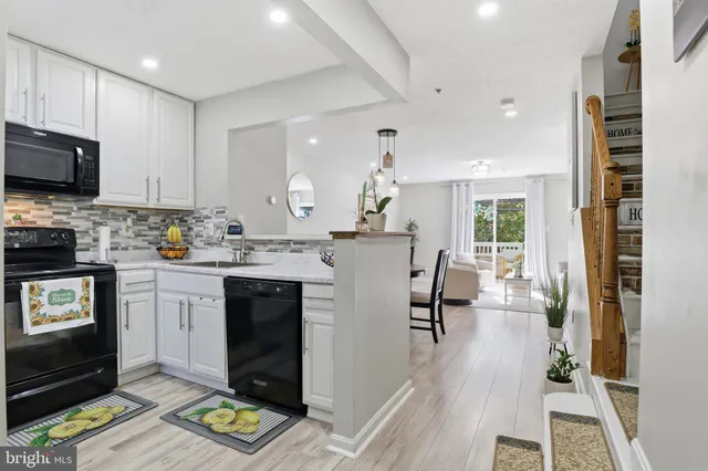 a kitchen with a refrigerator and a stove top oven