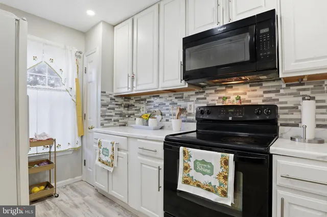 a kitchen with stainless steel appliances a stove a microwave and cabinets