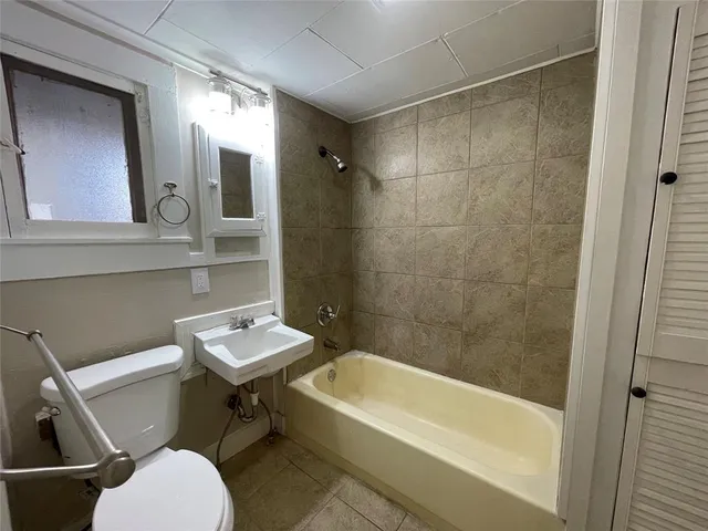 a bathroom with a toilet a sink and bathtub