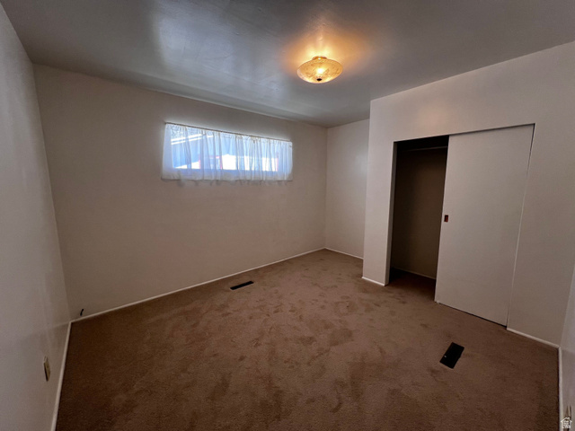 338 South 300 West Helper, UT 84526 - Photo 17 of 20 Unfurnished bedroom featuring carpet floors and a closet