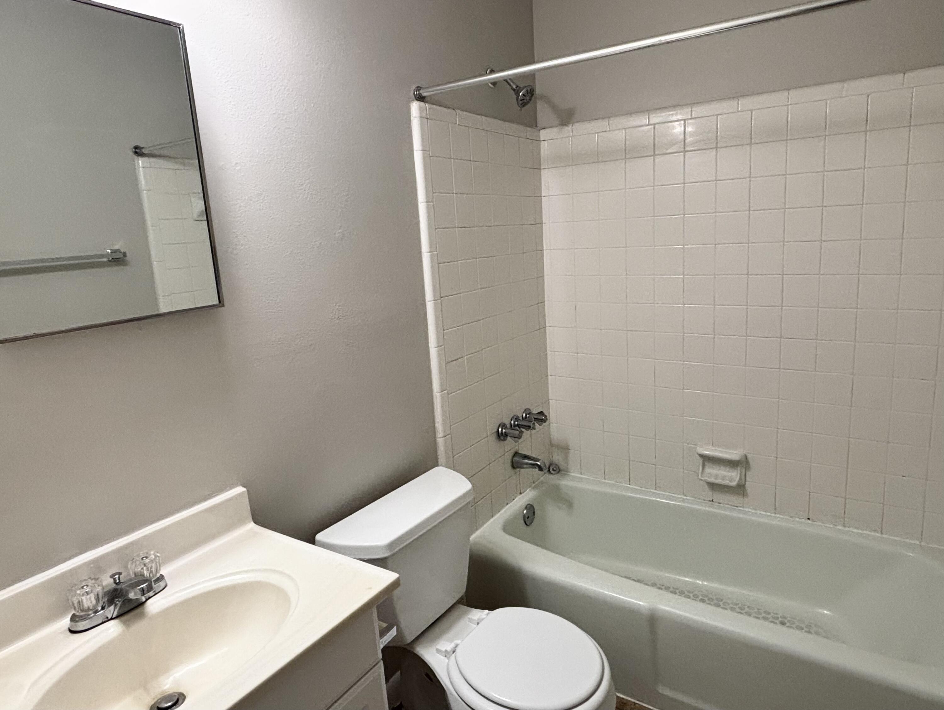 322 Pelham Road, Unit B Fort Walton Beach, FL 32547 - Photo 8 of 10 a bathroom with a sink toilet and shower